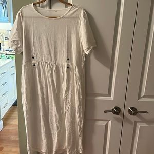 While gauzy dress with button detail and hidden pockets. Size large. New no tags
